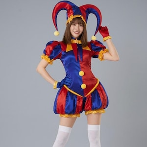 May include: A colorful jester costume in red, blue, and yellow. The outfit includes a hat with bells, a collared top, shorts, gloves, and wrist cuffs. The costume has a satin-like sheen and is trimmed with yellow ruffles.