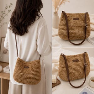 May include: A tan woven straw shoulder bag featuring a textured, basket-weave pattern, a rectangular brown leather-like brand patch on the front, and a long, adjustable dark brown shoulder strap with a silver-toned metal buckle for length adjustment.