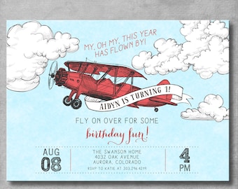 May include: A blue and white airplane birthday invitation with a red airplane flying through the clouds. The text reads "My, oh my, this year has flown by! Aidyn is turning 1! Fly on over for some birthday fun!"  The invitation includes the date, time, and location of the party.