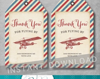 May include: Two red, white, and blue striped gift tags with a vintage airplane illustration and the text "Thank You for Flying By and Showering Me With Love".