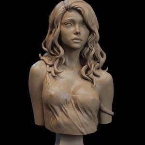 May include: A detailed bust sculpture of a woman with long, flowing hair and a draped garment. The sculpture is a light beige color and is set against a black background. The woman's expression is serene.
