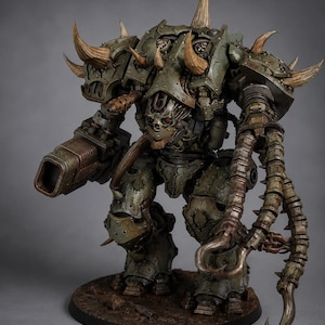 May include: A large, heavily armored mechanical figure painted in muted olive green with weathered metallic textures. The figure features multiple curved horns, a central skull-like faceplate with a red eye, a large cannon arm, and a clawed tentacle arm.