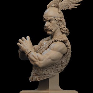 May include: A detailed bust sculpture of a warrior with a stern expression. The figure wears a helmet with wing accents and a textured vest. The sculpture is in a neutral color and is mounted on a rectangular base.