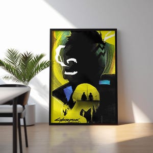 May include: A framed rectangular poster featuring a stylized graphic illustration with a vibrant yellow background. The artwork displays a large dark silhouette of a head, smaller figures in a yellow circle, and the text Cyberpunk at the bottom.