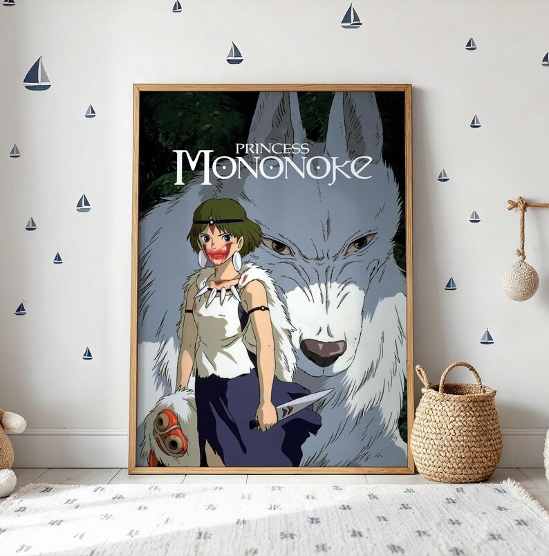 May include: A framed poster featuring the Princess Mononoke title with a character wearing a white top, dark skirt, and fur cape, standing before a large white wolf. The character has red markings on their face and holds a small knife.