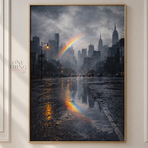 May include: A vertical wall art print depicting a rainy city street with a dark, cloudy skyline and tall skyscrapers. A vibrant rainbow arches across the grey sky, reflecting in the wet pavement below. The text ONE THING 365 appears on the left.