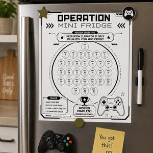 May include: A white and black Operation Mini Fridge chore chart with a gaming theme, featuring a 31-day calendar, rules, and a mission complete section. Includes a black game controller magnet and a yellow sticky note.
