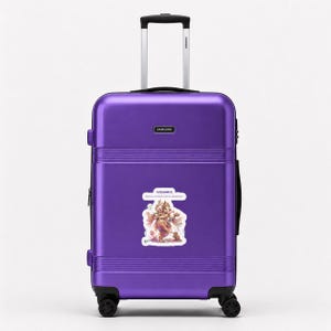 May include: A vibrant purple hard-shell suitcase with a retractable silver handle and four black wheels. A rectangular Samsung logo is centered near the top. A sticker featuring an illustration of Ganesha with the text Ganesha is centered.