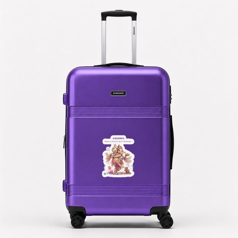 May include: A vibrant purple hard-shell suitcase with a retractable silver handle and four black wheels. A rectangular Samsung logo is centered near the top. A sticker featuring an illustration of Ganesha with the text Ganesha is centered.