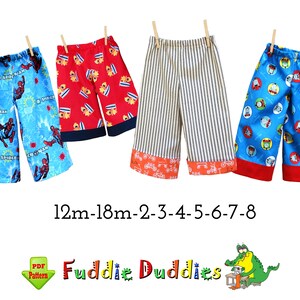 May include: Five pairs of colorful children's pants with different patterns. The pants are made of cotton fabric and have elastic waistbands. The sizes are 12m-18m, 2, 3, 4, 5, 6, 7, and 8. The text "Fuddie Duddies" is written below the pants.
