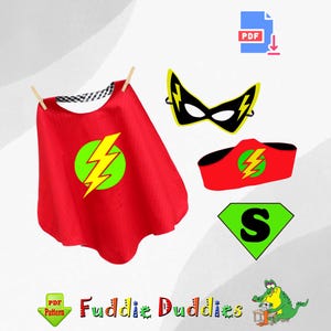 May include: A red superhero cape with a yellow lightning bolt in a green circle. A black mask with a yellow lightning bolt on each side. A red headband with a yellow lightning bolt in a green circle. A green diamond with a black letter "S" inside. The text "Fuddie Duddies" is on the bottom of the image.