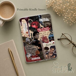 May include: A clear Kindle insert featuring a collage of The Vampire Diaries imagery, including a portrait of Damon, a red moon, a heart, a bourbon bottle, and text reading "I like my books with vampires," "Team Damon," and "hello, brother."
