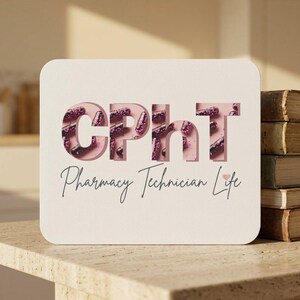 May include: A rectangular white sign featuring the bold, cutout-style letters CPhT filled with a pattern of purple and pink capsules on a light pink background. Below the letters, the text Pharmacy Technician Life is written in black script.