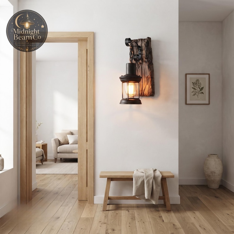 A vintage farmhouse wall sconce with a reclaimed wood plank backing and a black metal lantern suspended from a decorative scrolled iron hook and chain, perfect for entryways, porches, hallways, and covered patios.