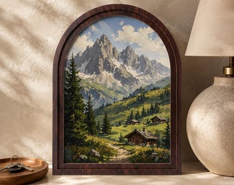 May include: An arched wooden frame containing a landscape painting of snow-capped mountains, green alpine meadows, and small wooden cabins. The scene features tall pine trees and a dirt path leading toward the houses under a blue sky with clouds.