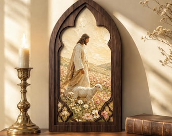May include: A pointed arch wooden frame containing a painting of a figure in robes walking through a field of flowers with a small lamb. The frame has a dark wood finish and a decorative gothic shape. The artwork depicts a pastoral landscape scene.
