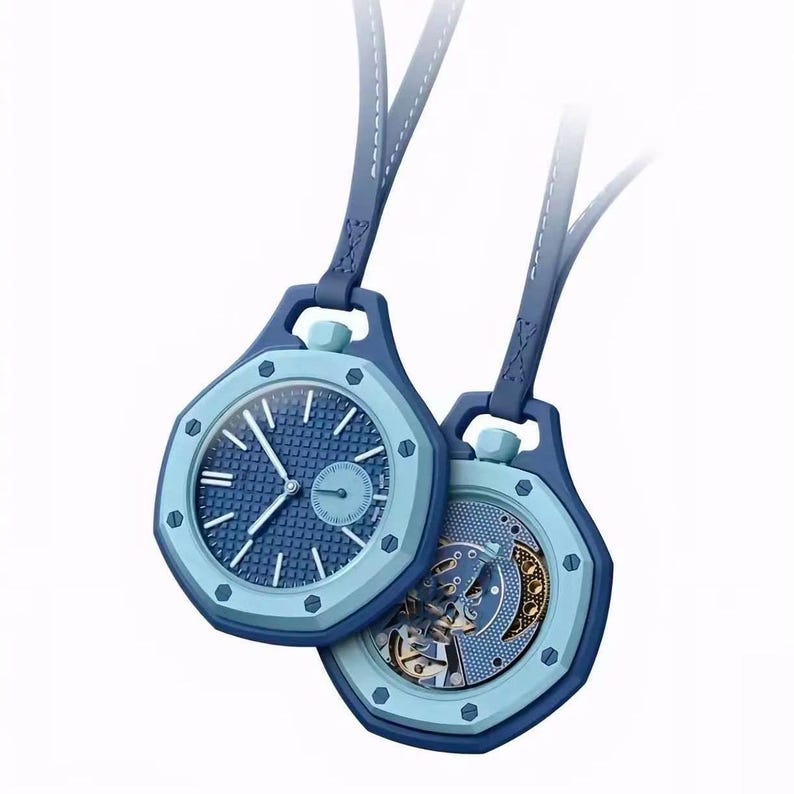 May include: Two blue octagonal pendant watches with leather straps. One watch displays a textured blue dial with silver hands and markers, while the other reveals an intricate mechanical movement with visible gears and a blue patterned plate.