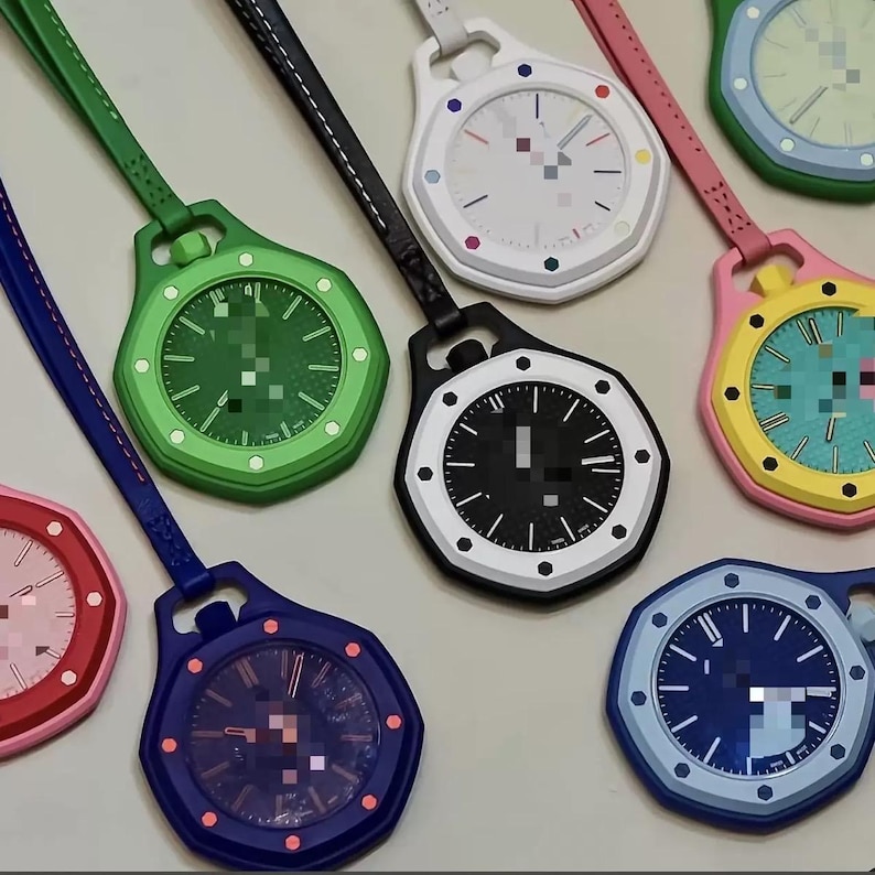 May include: A collection of octagonal pocket watches with matching colored straps. The watches feature various dial colors including green, black, white, blue, and yellow, each with contrasting hour markers and hands, arranged in a circular pattern.