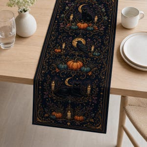 May include: A dark navy blue table runner featuring a repeating pattern of black cats, ravens, orange pumpkins, glowing candles, crescent moons, and spiderwebs, all framed by intricate gold-colored filigree and botanical scrollwork designs.