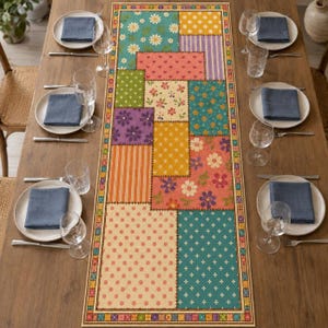 May include: A rectangular table runner featuring a patchwork design of various colorful patterns including floral prints, polka dots, and vertical stripes in shades of teal, orange, yellow, purple, and pink, centered on a wooden dining table.