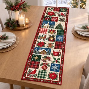 May include: A rectangular table runner featuring a patchwork design of Christmas-themed squares. The pattern includes illustrations of poinsettias, cardinals, snowflakes, a gingerbread man, a reindeer, a cabin, and plaid fabric textures.