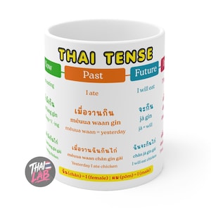 May include: A white ceramic mug featuring a colorful educational chart titled THAI TENSE. The design includes columns for Past and Future tenses with Thai script, phonetic pronunciations, and English translations, plus a Thai Lab logo.