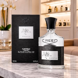 May include: A Creed Aventus 100 ml, 3.3 fl. oz. glass perfume bottle with a black cap and a black textured label featuring a horse and rider logo, accompanied by its matching black rectangular cardboard box with the same branding and text.