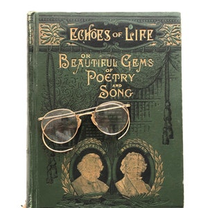 May include: A vintage book, "Echoes of Life or Beautiful Gems of Poetry and Song", with gold lettering and illustrations. A pair of round, gold-rimmed spectacles sits on the green cover. The book has gold detailing.