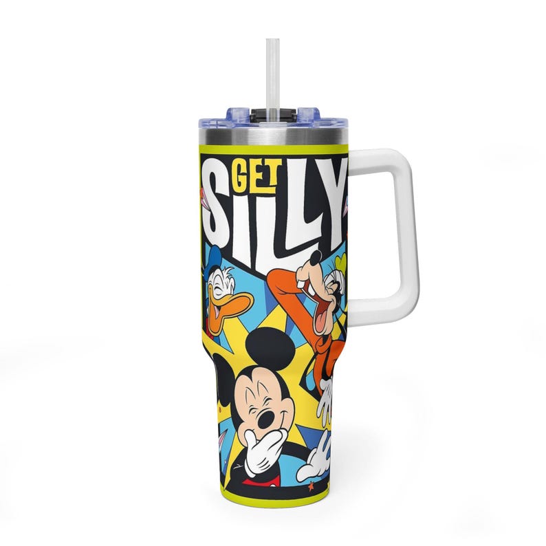 Peut inclure: Un gobelet &agrave; poign&eacute;e blanche avec Mickey Mouse, Donald Duck et Dingo avec les mots "GET SILLY" dans un design color&eacute;. Le gobelet a une paille et un couvercle bleu.