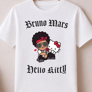 May include: White t-shirt featuring a graphic of Bruno Mars and Hello Kitty. The design includes the text "Bruno Mars" above the illustration and "Hello Kitty" below. The shirt is hanging on a wooden hanger.