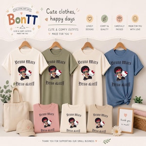 May include: A display of t-shirts in various colors, including white, olive green, and blue, featuring a graphic of Bruno Mars with Hello Kitty. The shirts are part of a collection of cute and comfy outfits. The text "Bruno Mars" and "Hello Kitty" are printed on the shirts.