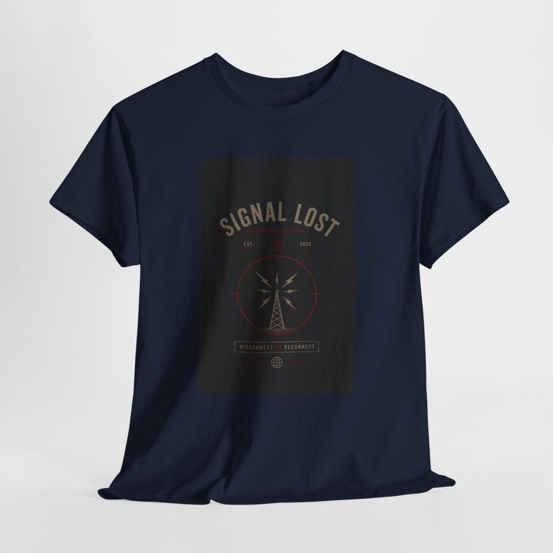 May include: Navy blue t-shirt with a graphic that reads "SIGNAL LOST" above a radio tower design. The design is in shades of gray, red, and white. The shirt is a classic crew neck style.