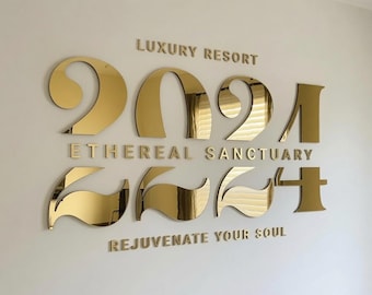 May include: A gold mirrored wall sign featuring the text LUXURY RESORT, ETHEREAL SANCTUARY, and REJUVENATE YOUR SOUL, with the year 2024 displayed in large, stylized, reflective gold numerals positioned between the lines of text.