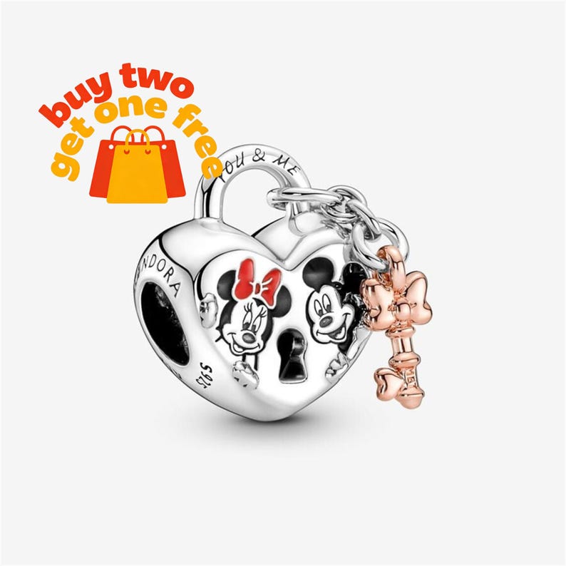May include: A silver heart-shaped padlock charm featuring engraved images of Mickey and Minnie Mouse with red accents. The charm includes a small rose gold-toned key attached by a chain, with the Pandora brand name and S925 hallmark visible.