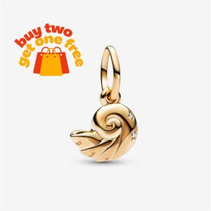 May include: A gold-toned seashell charm featuring a spiral design with two small embedded clear stones and a circular bail at the top. The charm includes the text "buy two get one free" with a graphic of three shopping bags in the upper left.