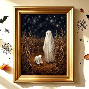 May include: A framed wall art piece featuring a painting of a ghost and a small ghost-costumed dog standing in a dry cornfield under a starry night sky. The gold frame is surrounded by wall decals of black bats, spiderwebs, orange pumpkins, and leaves.