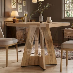 May include: A square wooden dining table featuring a light oak finish with a prominent grain pattern. The table is supported by a central pedestal base composed of four angled, intersecting wooden panels that form a sturdy, geometric structure.