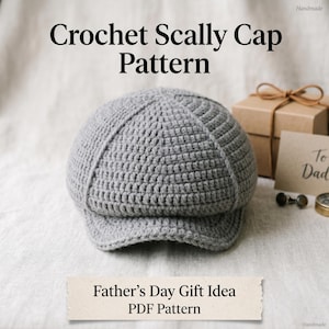 May include: A gray crocheted scally cap with a small brim, displayed on a neutral surface. The image includes text that reads "Crochet Scally Cap Pattern" and "Father's Day Gift Idea PDF Pattern". A gift box and a card that says "To Dad" are also visible.