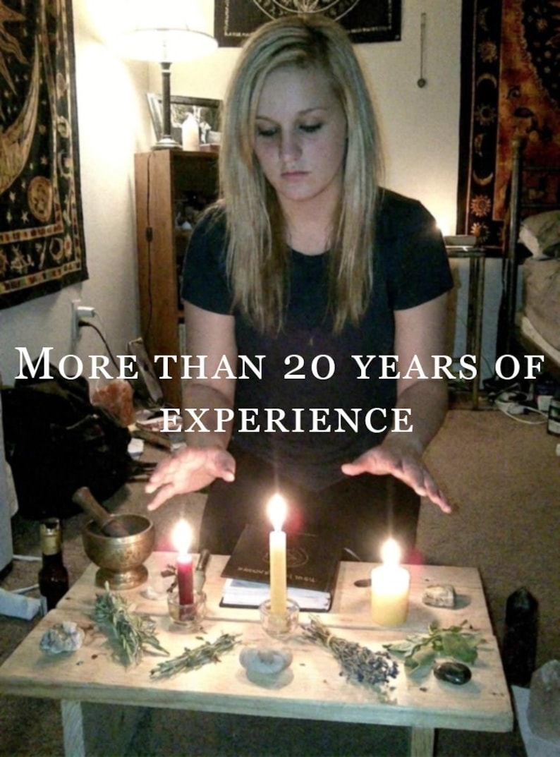 May include: A wooden table holds three lit candles, a mortar and pestle, various dried herbs, stones, and a book. The text "MORE THAN 20 YEARS OF EXPERIENCE" is overlaid on the image. The scene includes a person with blonde hair in a dark shirt.
