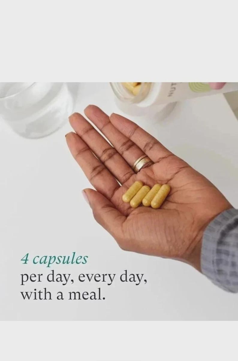 May include: Four yellow capsules are held in a person's hand. The text below the hand reads: "4 capsules per day, every day, with a meal."