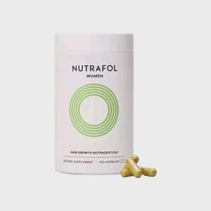 May include: A white cylindrical bottle of Nutrafol Women hair growth nutraceutical dietary supplement. The bottle has a green circular design and the text "Nutrafol Women". Three yellow capsules are in front of the bottle. The bottle contains 120 capsules.