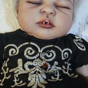 blood droplet necklace (fake blood), and fangs from a real mink