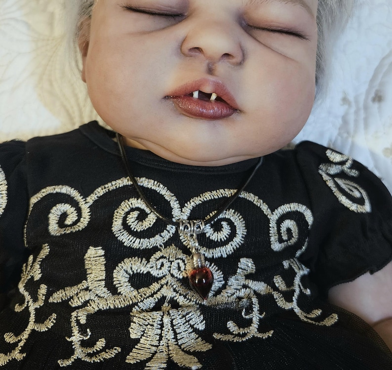 blood droplet necklace (fake blood), and fangs from a real mink