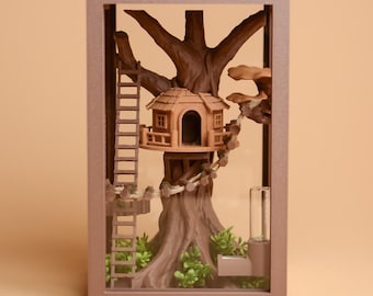 May include: A rectangular brown frame containing a three-dimensional treehouse model. The scene features a brown tree with a small house, a ladder, a rope bridge, and green foliage at the base. A clear cylindrical component is attached to the side.