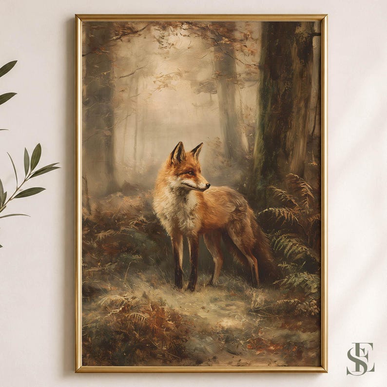May include: A framed wall art print featuring a red fox standing in a misty, sunlit forest. The fox has orange and white fur and is positioned among dark tree trunks and green ferns. The artwork is enclosed in a thin, metallic gold frame.