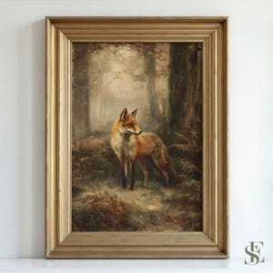 May include: A framed wall art print featuring a red fox standing in a misty, wooded forest. The fox has orange and white fur and is positioned near a large tree trunk. The artwork is encased in a decorative, metallic gold-toned frame.