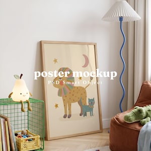 Op de afbeelding: Een rechthoekige houten lijst met een poster op een beige achtergrond, met een gevlekte leeuw met een regenboogkleurige manen en een kleine blauwe kat, versierd met sterren en een halve maan. De tekst "poster mockup PSD Smart Object" is zichtbaar.