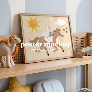 May include: A rectangular wooden frame containing a poster with a light beige background, featuring a brown horse with a rainbow-colored mane and tail, a white goose, and a small gray mouse. The illustration includes a yellow sun, white clouds, and small stars, with the text "poster mockup PSD Smart Object" overlaid in white.