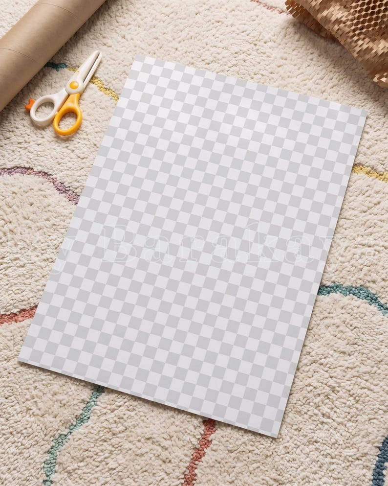 May include: A rectangular sheet of paper featuring a repeating light grey and white checkerboard pattern. The paper is positioned flat, accompanied by a pair of white and yellow scissors and a brown cardboard tube nearby.