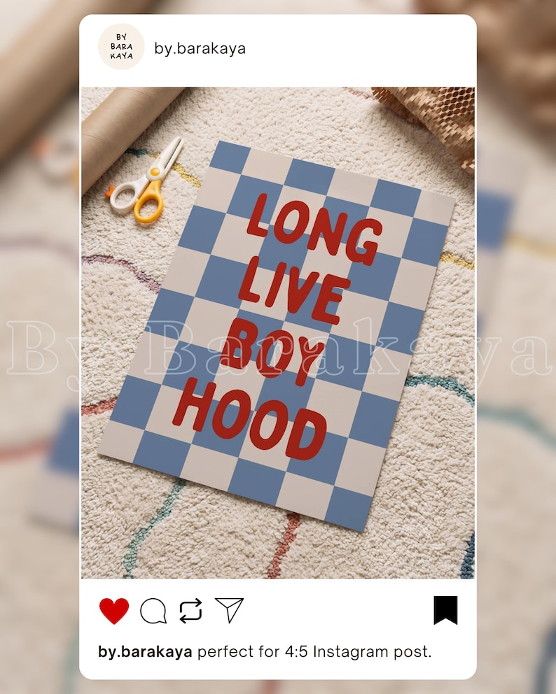 May include: A rectangular print featuring a blue and off-white chequered pattern with the red text LONG LIVE BOYHOOD centred on the surface. The print is displayed alongside a pair of white and yellow scissors on a textured white surface.